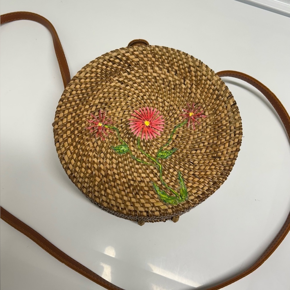 Handwoven round rattan crossbody bag.